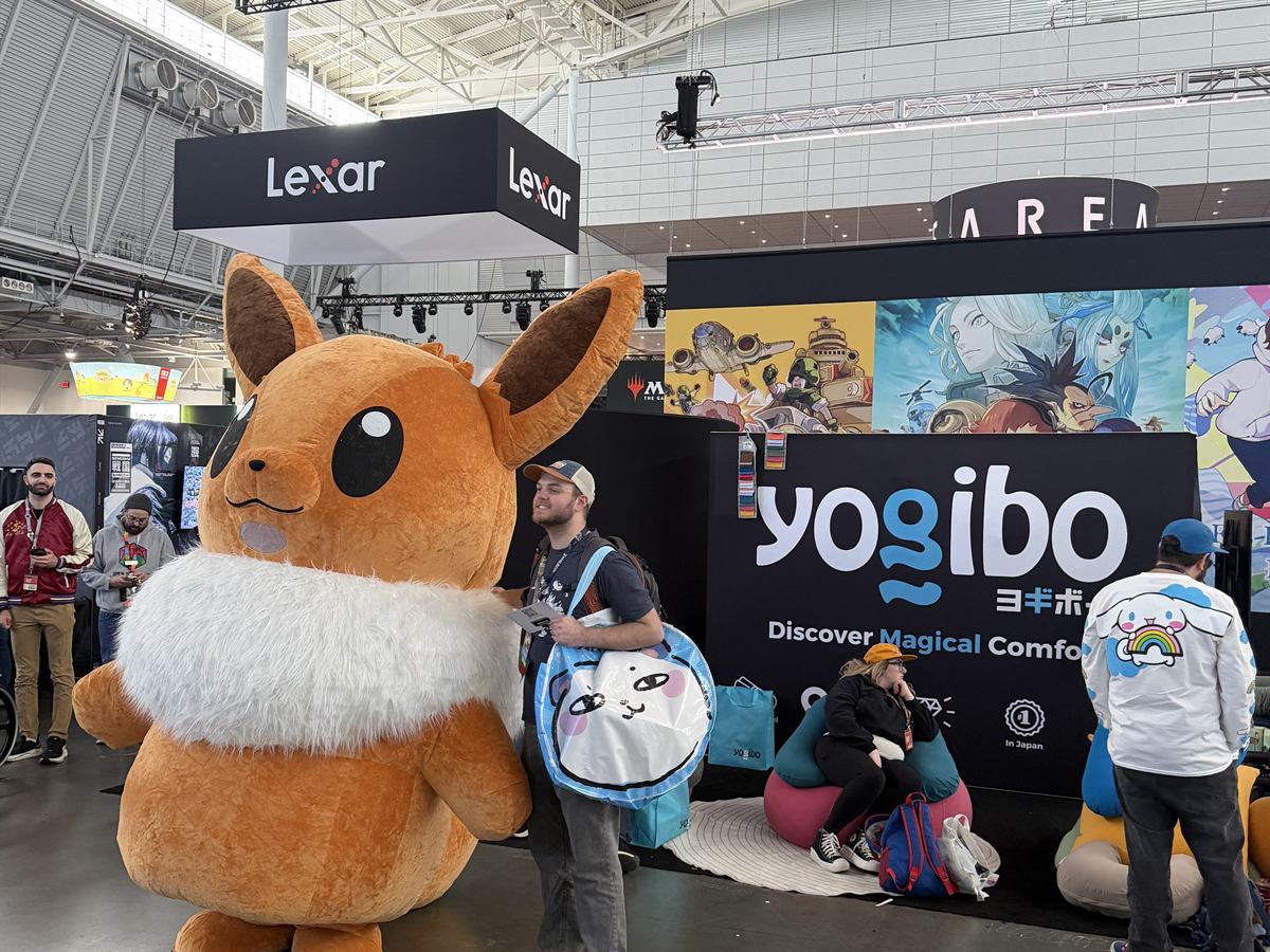 A mascot greeting visitors at the Yogibo booth