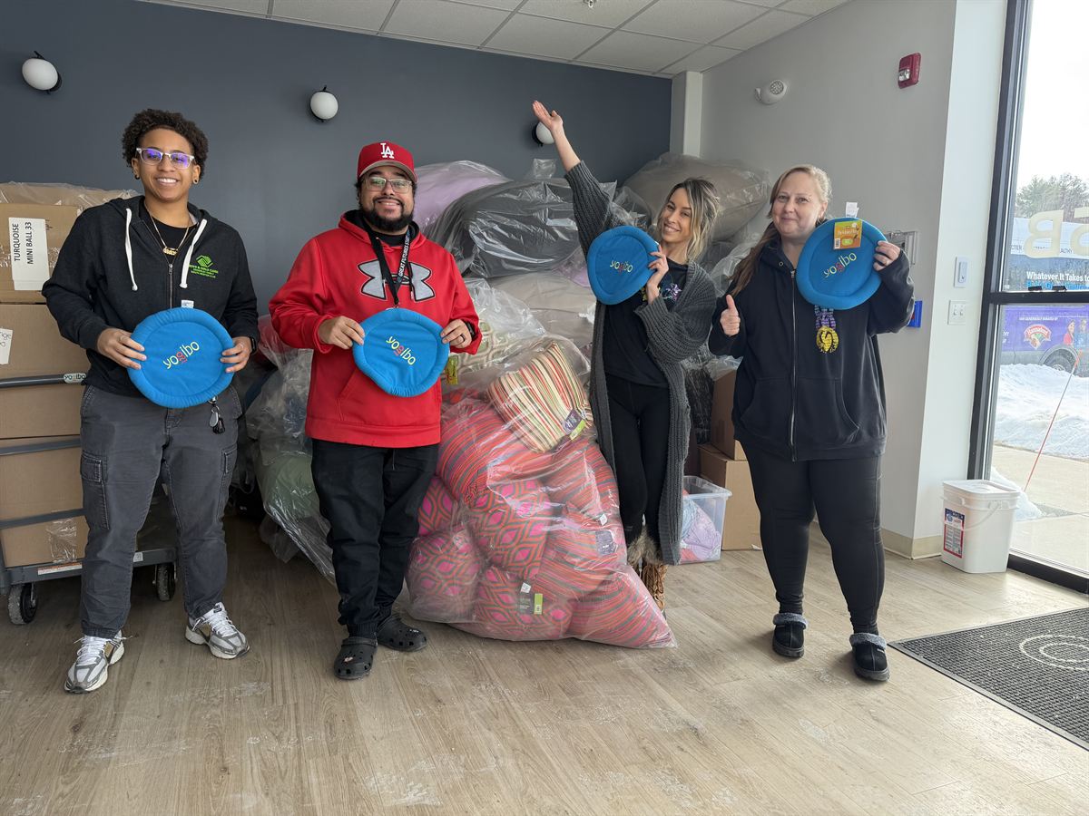 Boys and Girls Club staff with a donation of Yogibo products
