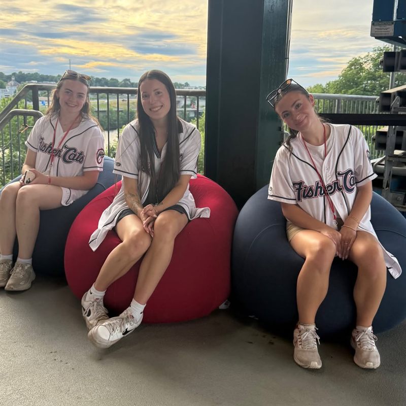 Staff in New Hampshire Fisher Cats jerseys sitting on Yogibo bean bags at the ballpark