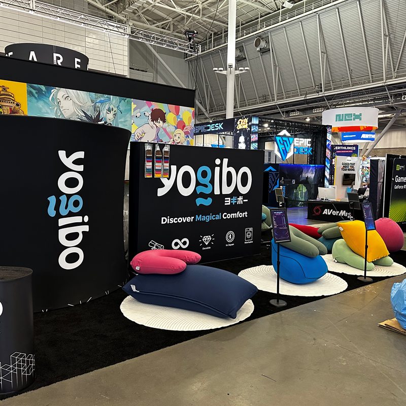 The teal-lit Yogibo booth wall at PAX East