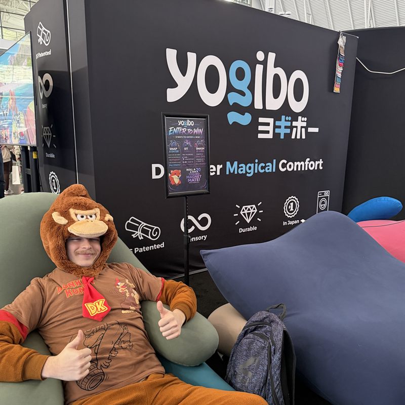 A cosplayer relaxing on a Yogibo at the PAX West booth